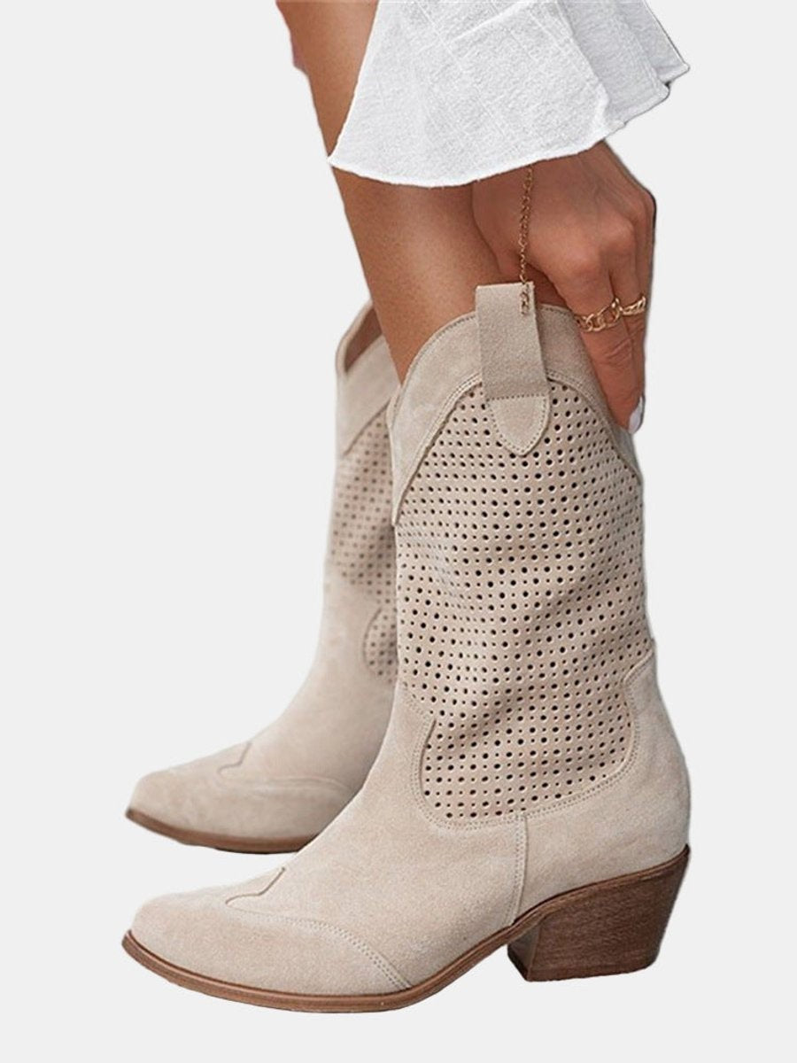 model pulling on beige perforated suede western-style boots