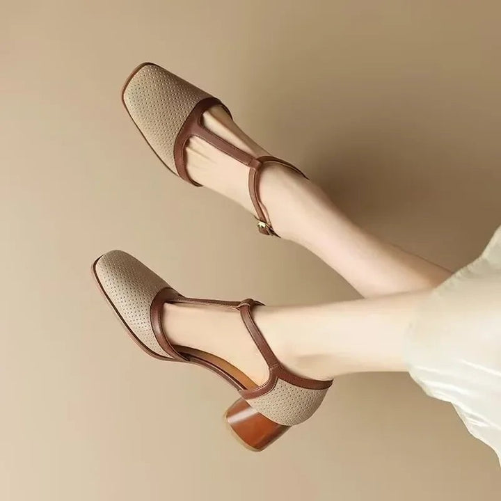 Pair of beige square toe T-strap pumps with brown accents and stacked heel
