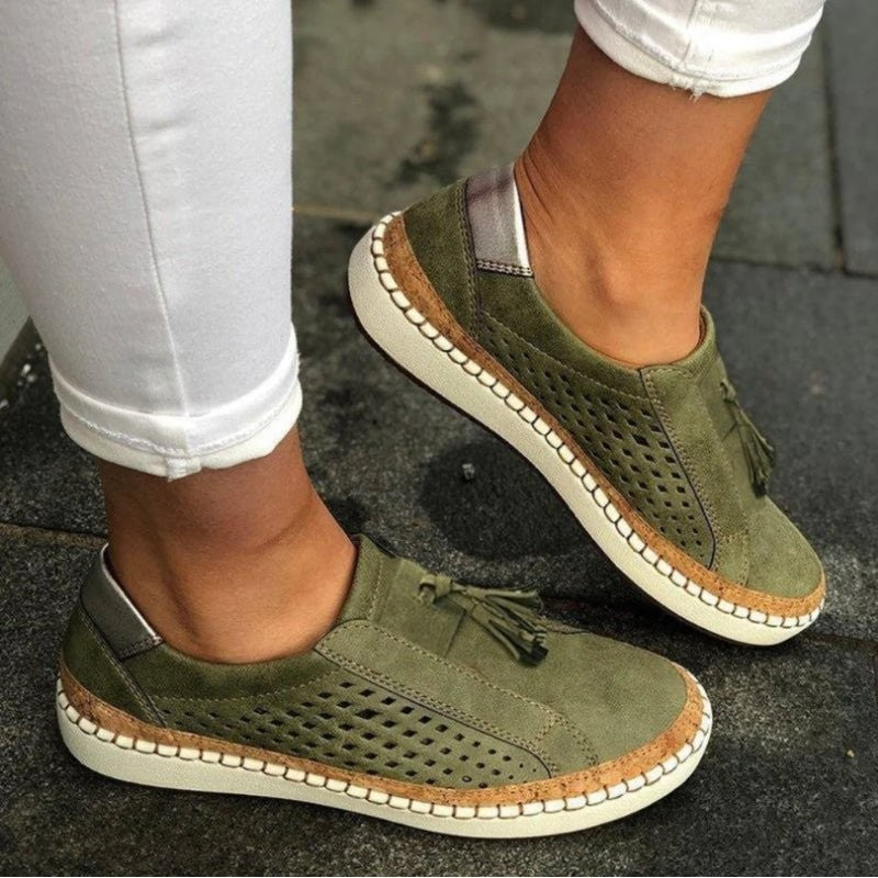 olive green perforated slip-on sneakers with tassel detail and stitched sole