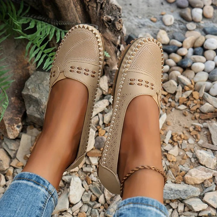 Tan perforated flats with scalloped edge and hand-stitched detailing