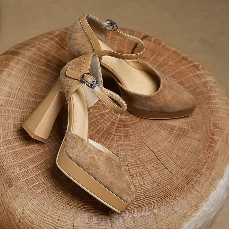 Suede block heel pumps in tan paired with a floral accent