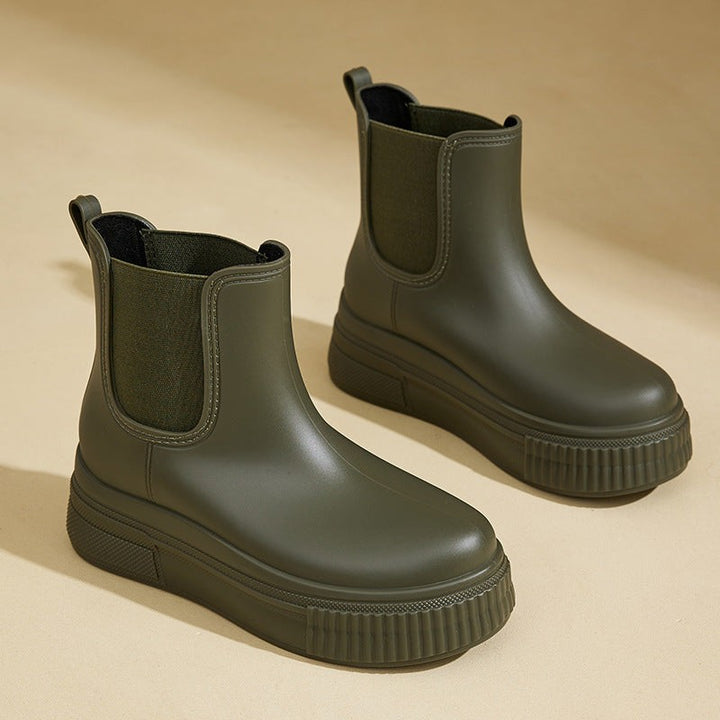 Olive green Chelsea rain boots with chunky platform sole and elastic side panel