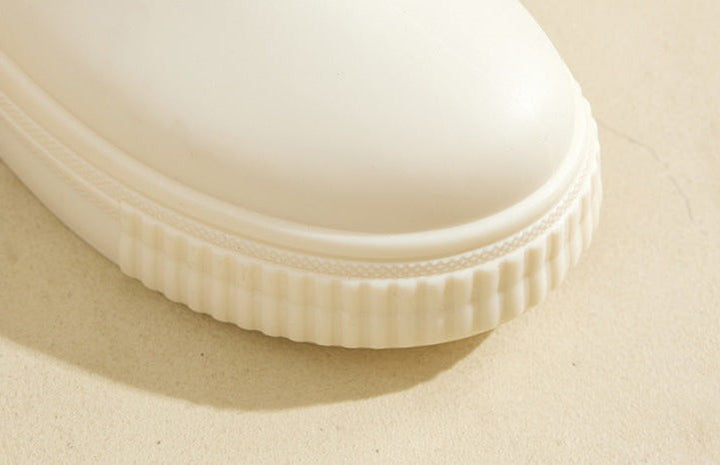 Close-up of ivory boot toe showing ribbed platform edge detail