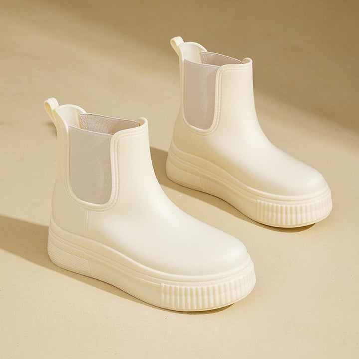 Ivory Chelsea rain boots featuring ribbed platform sole and pull-tab heel