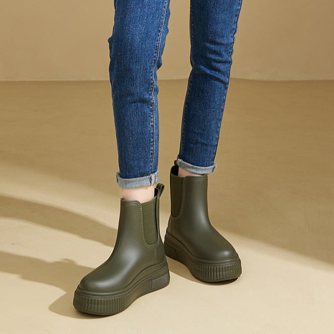 Model wearing olive green platform Chelsea boots paired with cuffed jeans