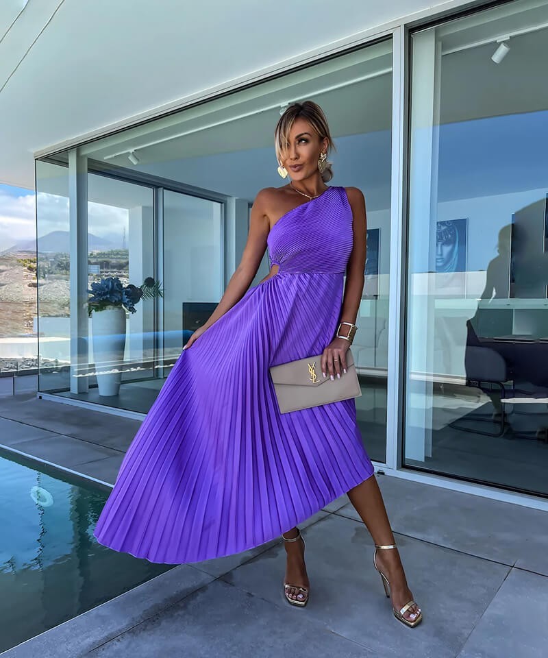 one-shoulder pleated purple dress styled with metallic gold heels poolside
