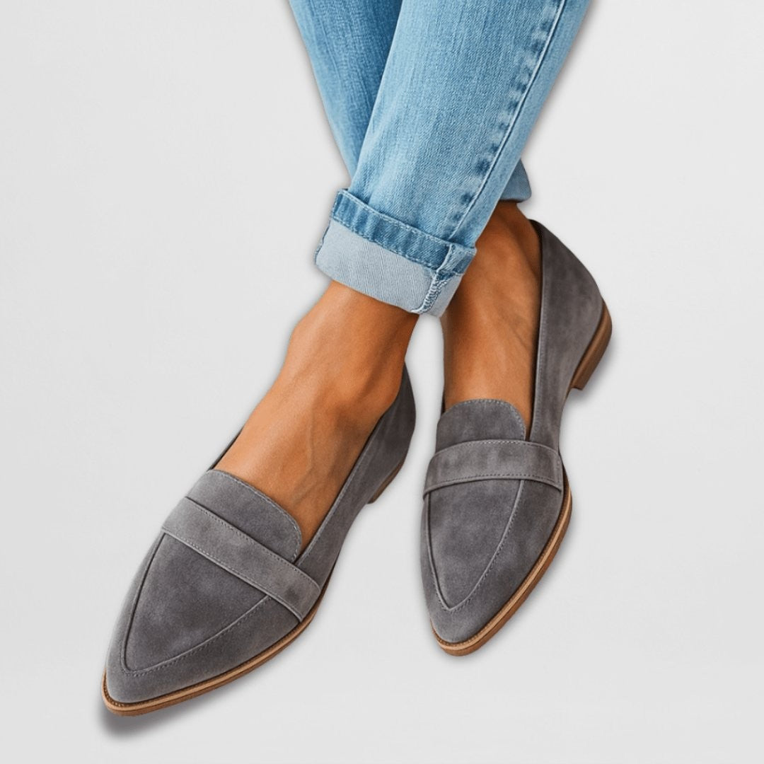 gray suede pointed-toe slip-on loafers styled with cuffed denim