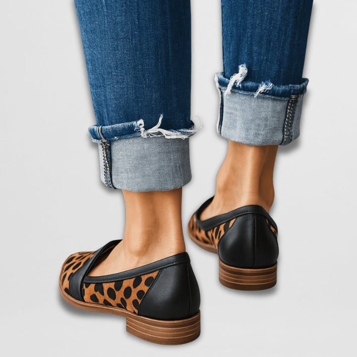 leopard-print loafers with black heel counter, back view with denim