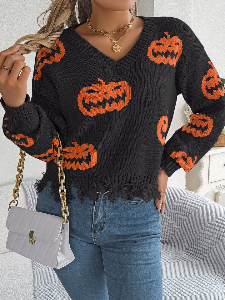 Close-up of black Halloween sweater with orange jack-o-lantern print