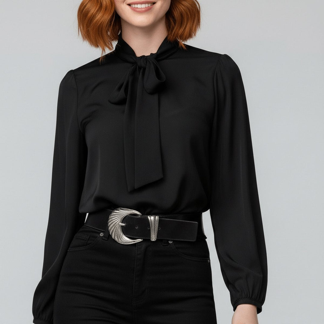 black bow-tie neck blouse with satin sheen paired with a statement belt