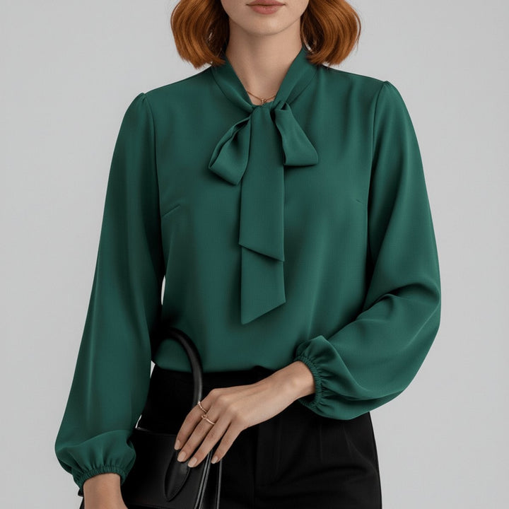 close-up of emerald green bow-tie blouse with elastic cuffs and puff sleeves
