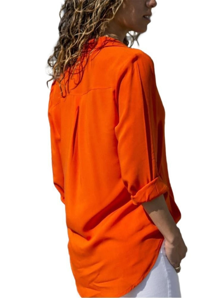 back view of orange relaxed-fit blouse with rolled cuffs and curved hem