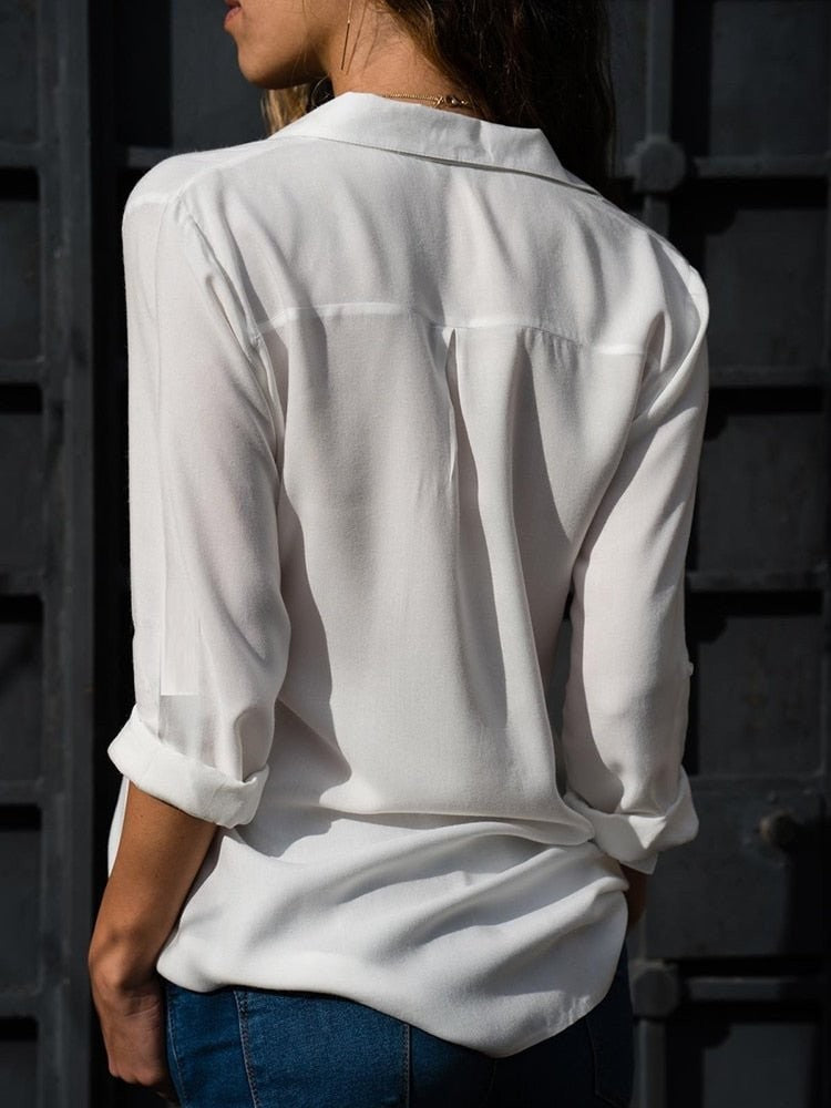 back view of white relaxed-fit blouse with rolled sleeves and curved hem