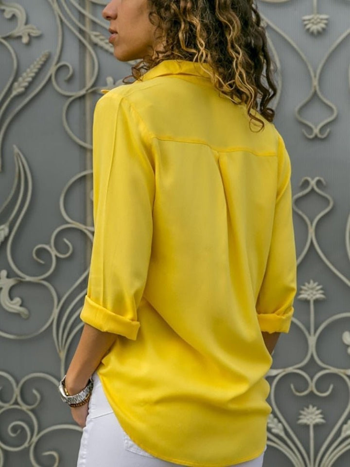 back view of yellow relaxed-fit blouse with pleated back detail