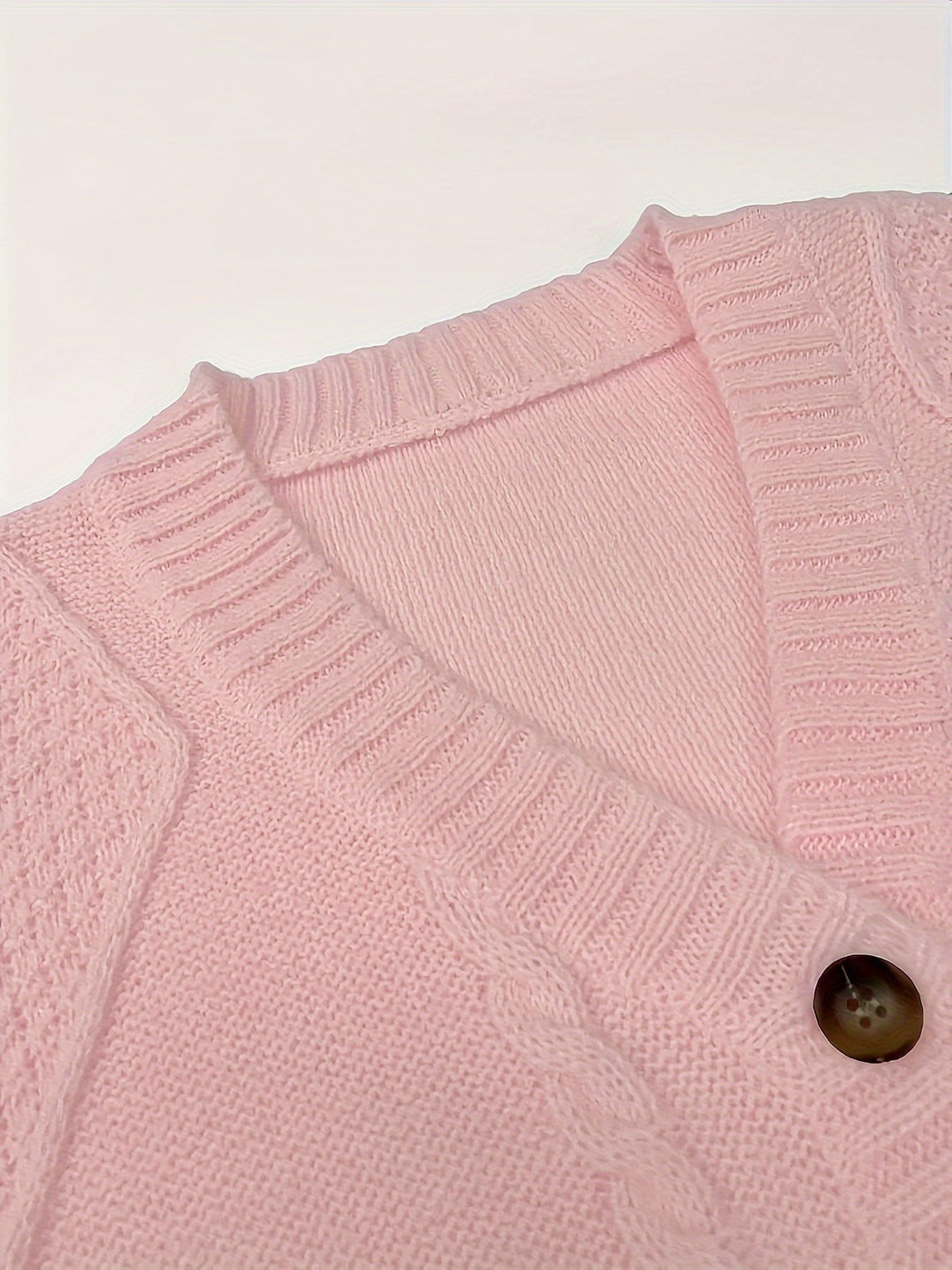 Close-up of pink cardigan collar and tortoiseshell button