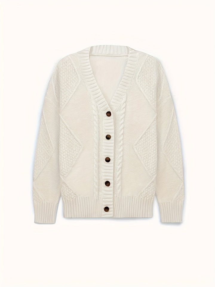 Flat lay of white cable-knit cardigan with textured diamond pattern