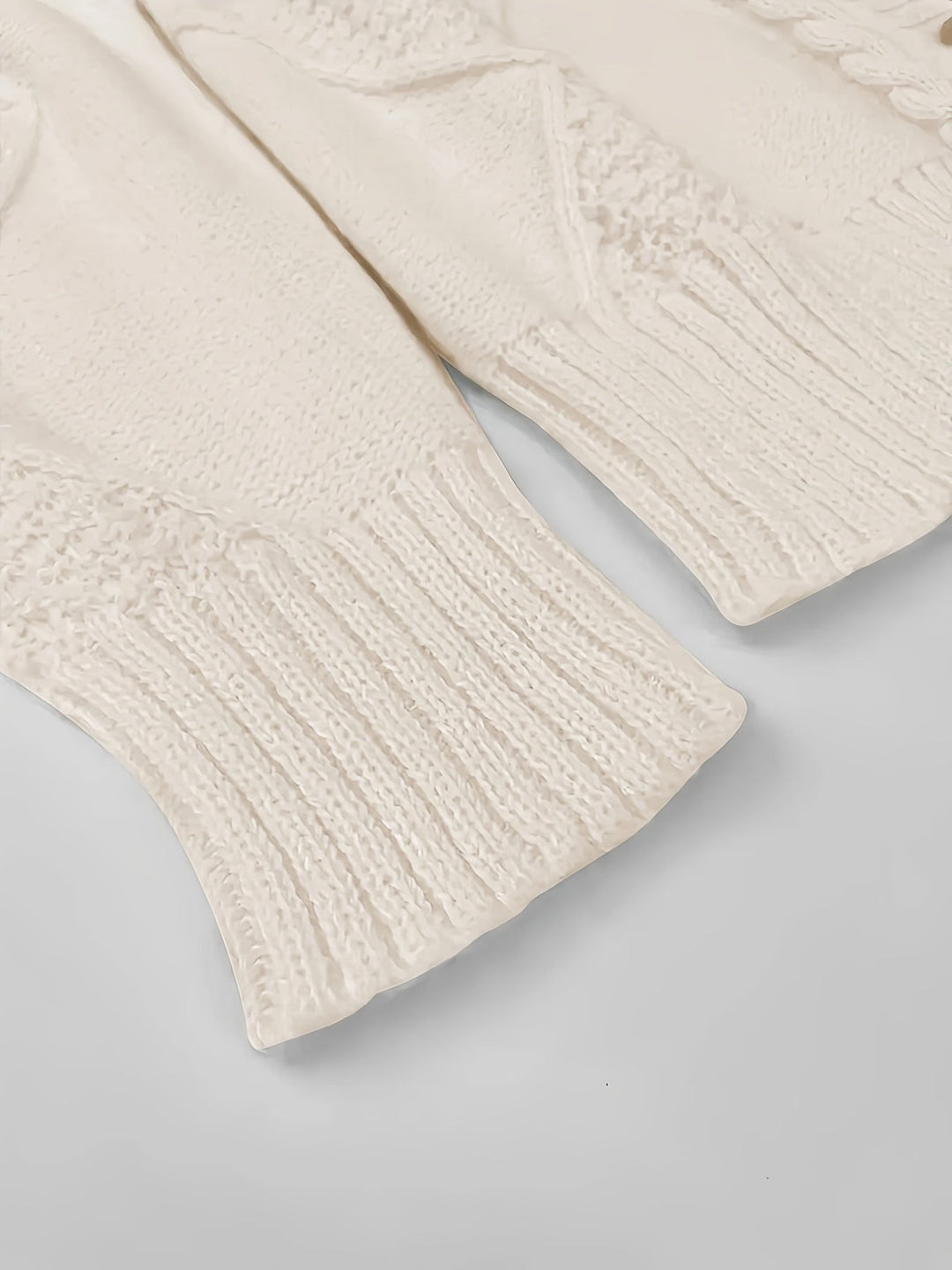 Close-up of white knit sweater cuff with ribbed texture