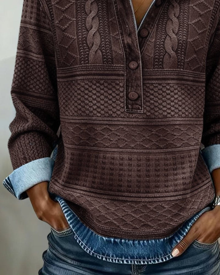 Brown textured knit sweater showing cable-stitch pattern and buttons
