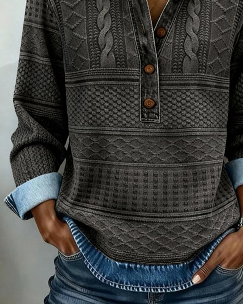 Gray cable-knit half-button sweater with folded denim cuffs
