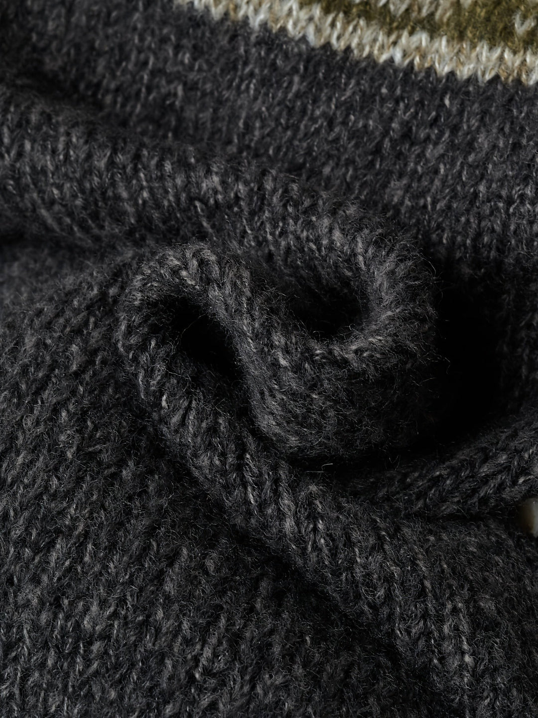 Close-up of ribbed knit texture on black cardigan sleeve