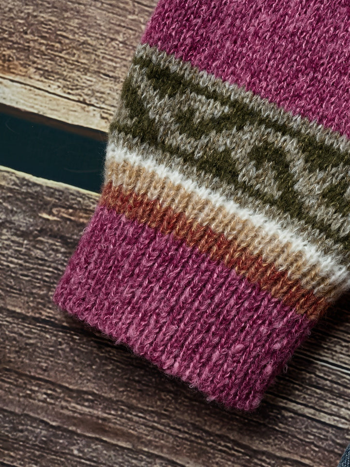 Close-up of ribbed cuff and Fair Isle pattern on magenta cardigan