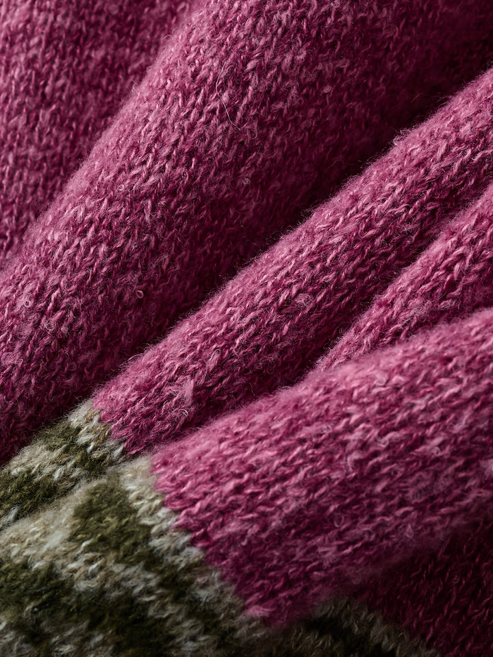 Folded magenta knit fabric texture detail on patterned cardigan