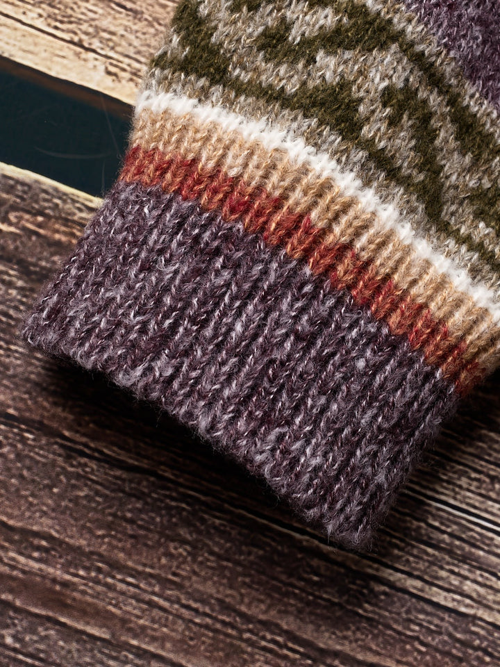 Folded purple knit fabric texture detail on patterned cardigan