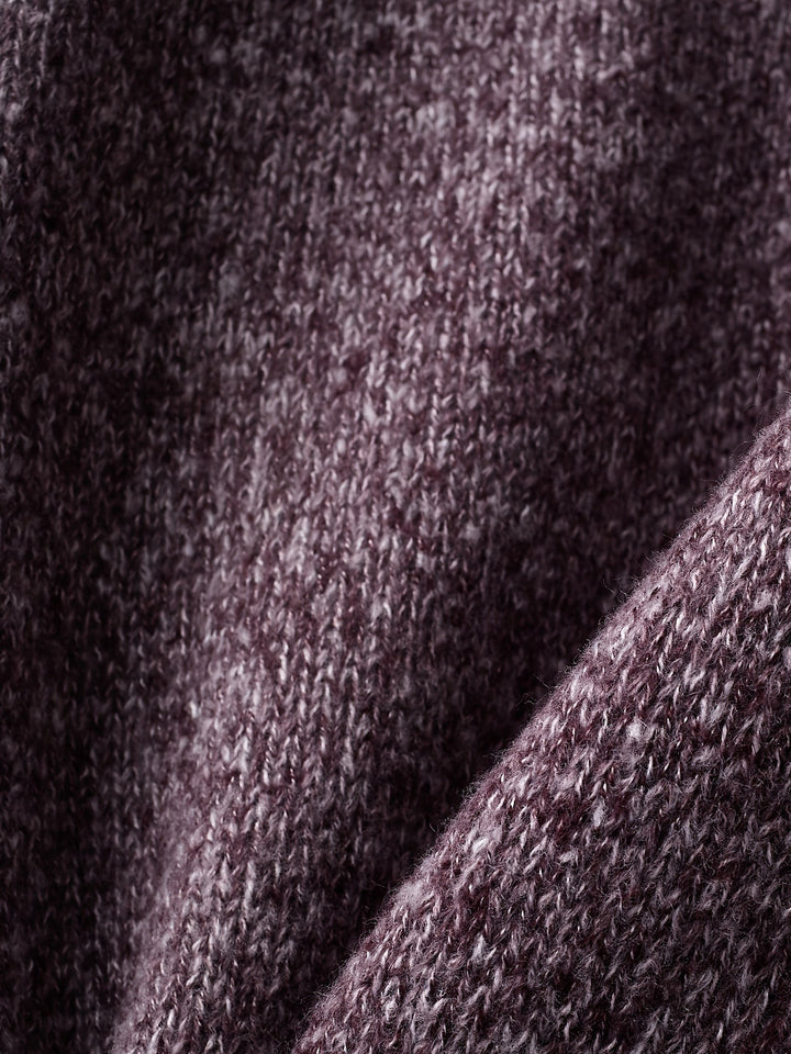 Folded purple knit fabric close-up showing soft ribbed texture