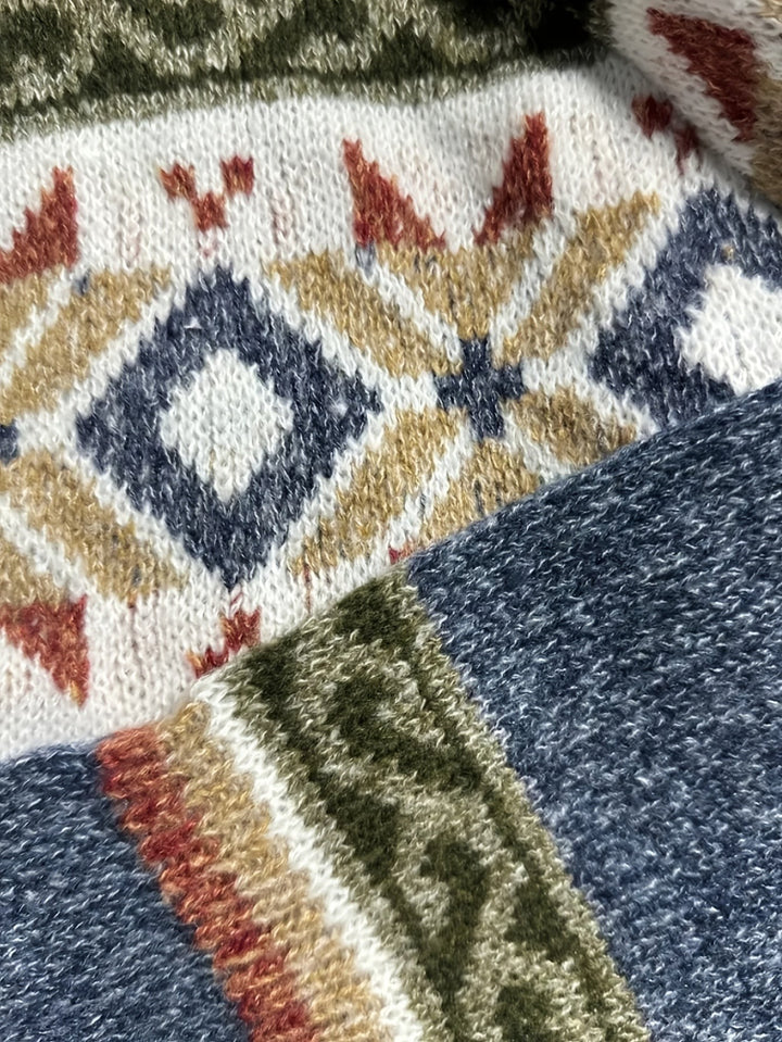 Close-up of Fair Isle knit pattern with diamond motifs on blue cardigan