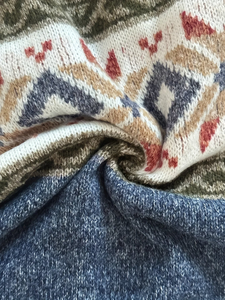 Folded knit fabric detail showing diamond pattern and blue color block