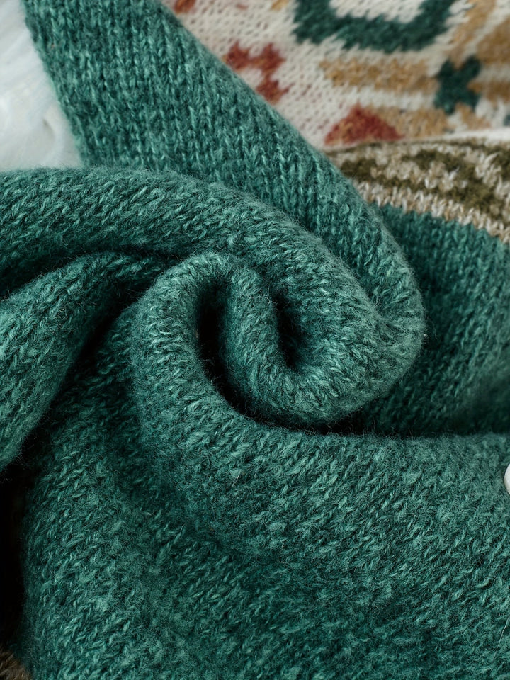 Folded green knit fabric texture detail on patterned cardigan