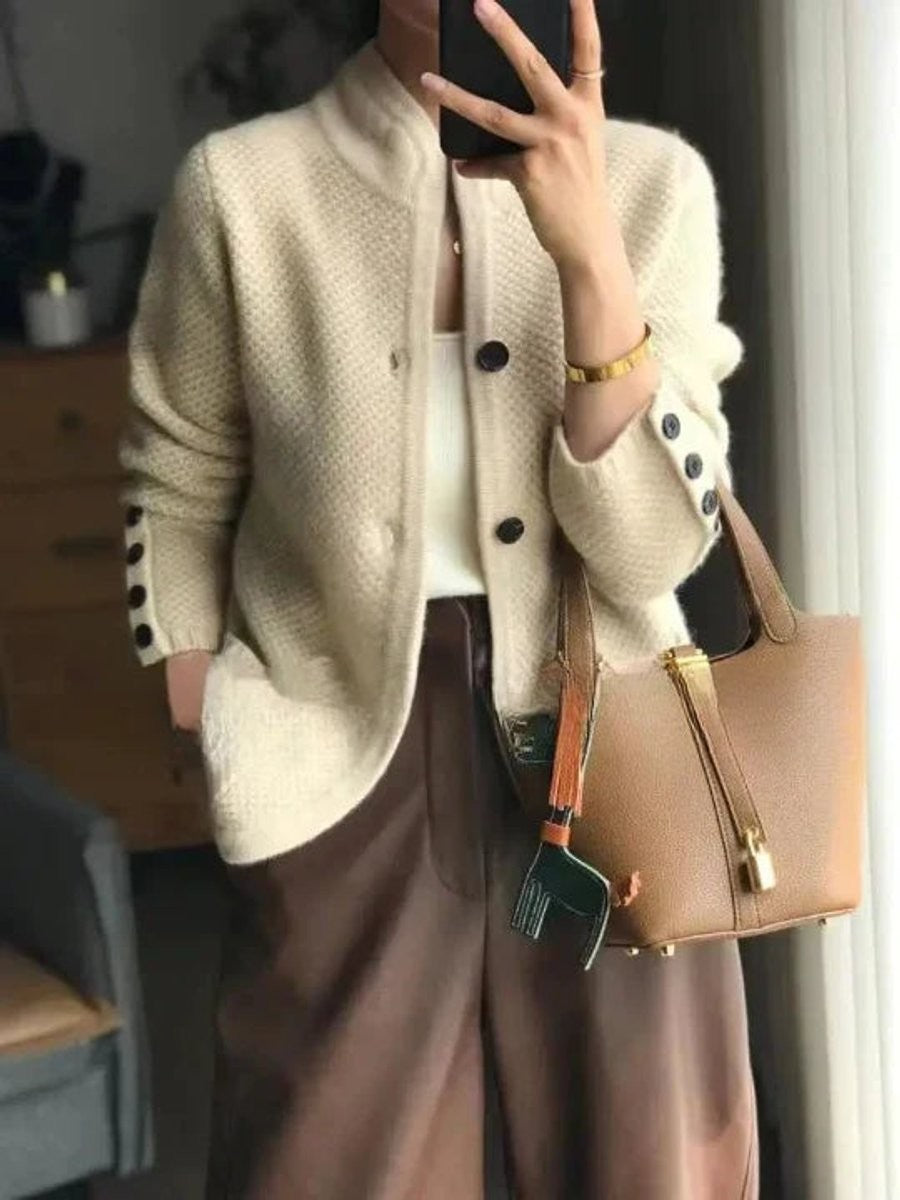 Cream knit cashmere cardigan with black buttons and stand collar
