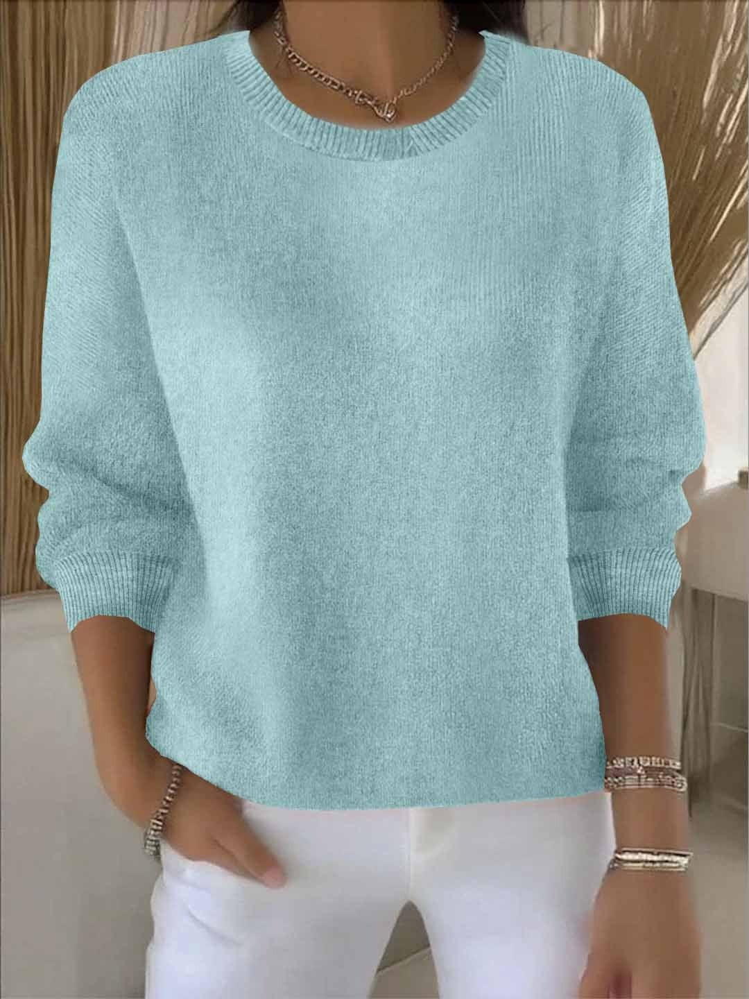 Mint green knit sweater featuring ribbed trim and oversized sleeves