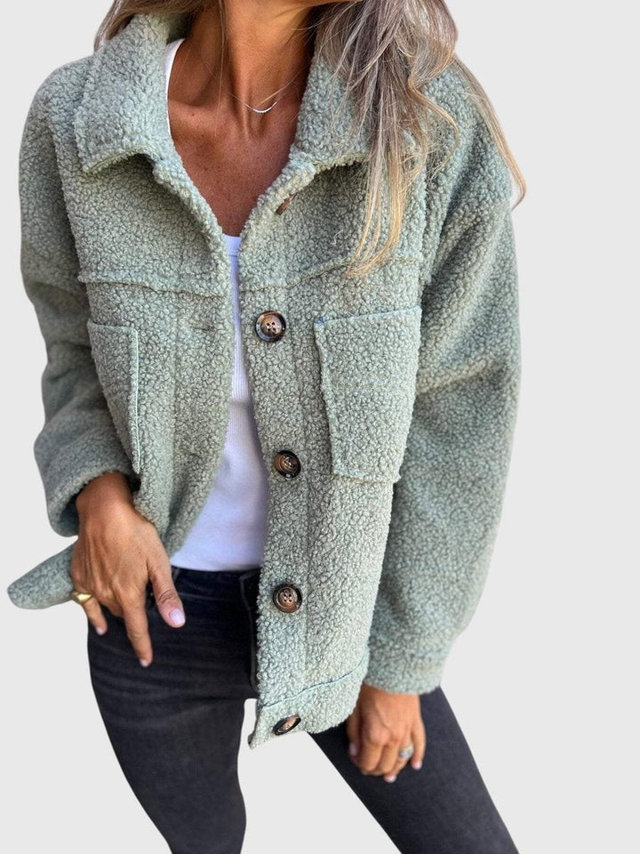 Sage green sherpa fleece jacket styled with dark denim jeans
