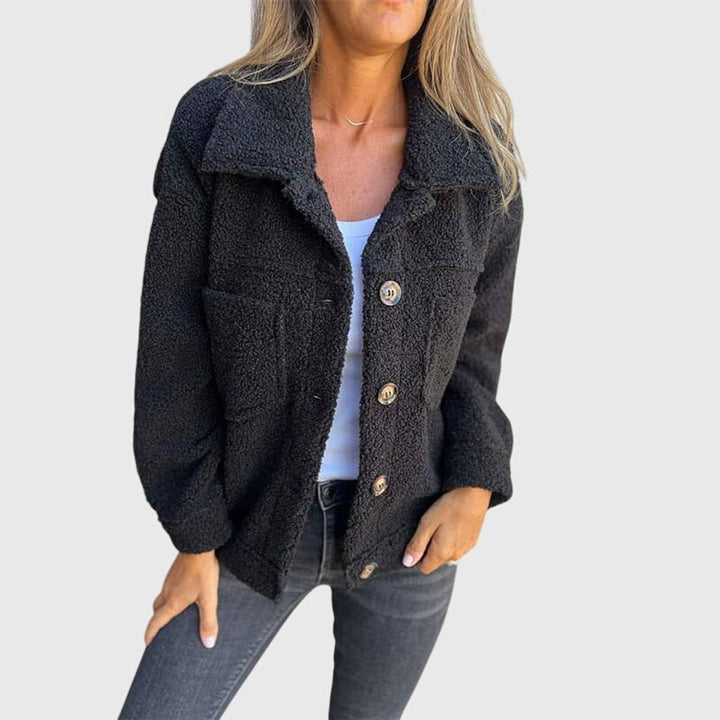 Black button-front sherpa coat paired with a white tank top