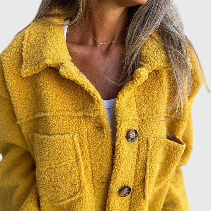 Close-up of mustard yellow sherpa fleece jacket collar and buttons