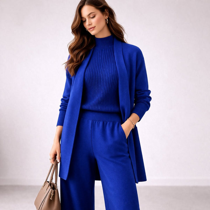 Cobalt blue knit lounge set with open cardigan, mock neck top, and wide pants