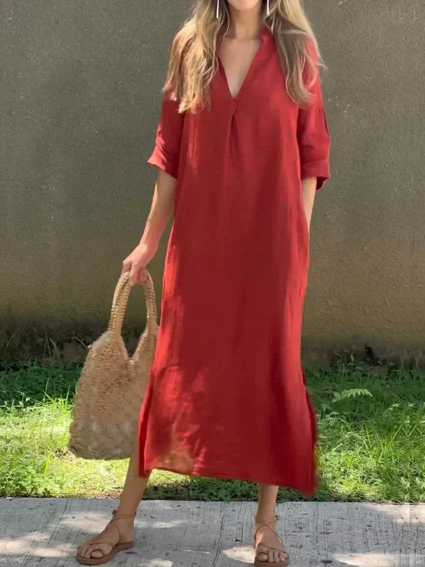 Red V-neck linen maxi dress paired with woven tote and sandals