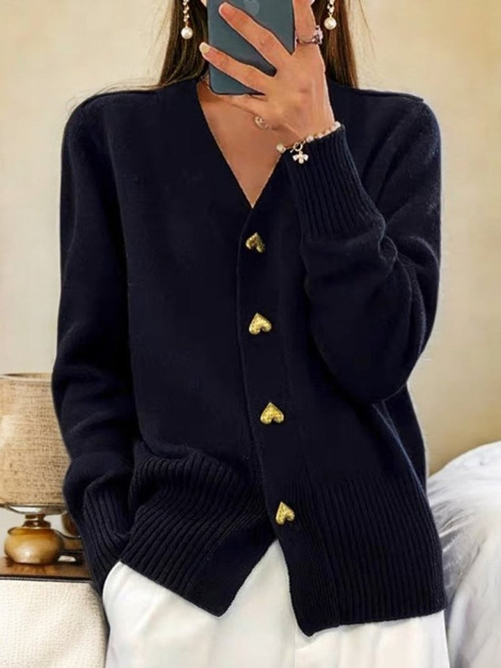 Navy knit cardigan with gold heart-shaped buttons and V-neck design