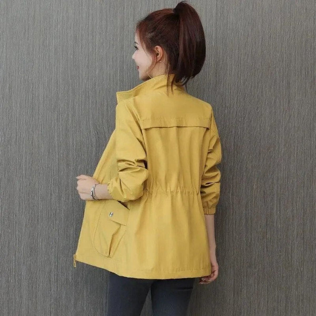 Mustard yellow drawstring bomber jacket shown from behind with flap pocket