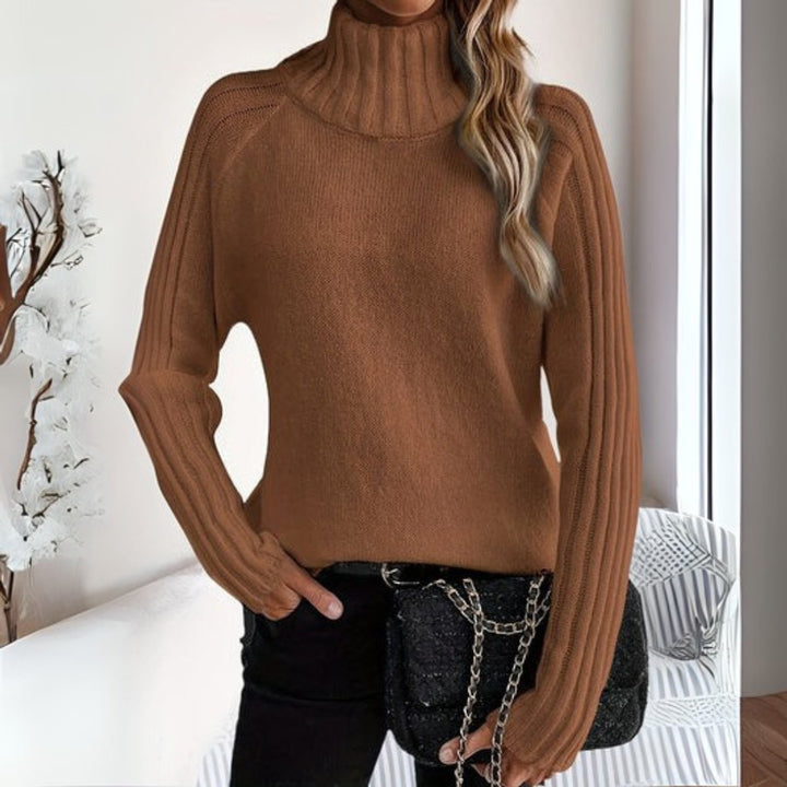 Camel ribbed turtleneck sweater featuring relaxed knit sleeves and quilted handbag