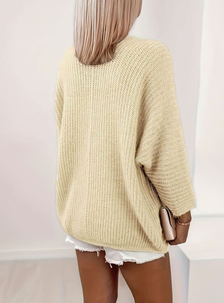 back view of cream oversized knit cardigan showing ribbed texture