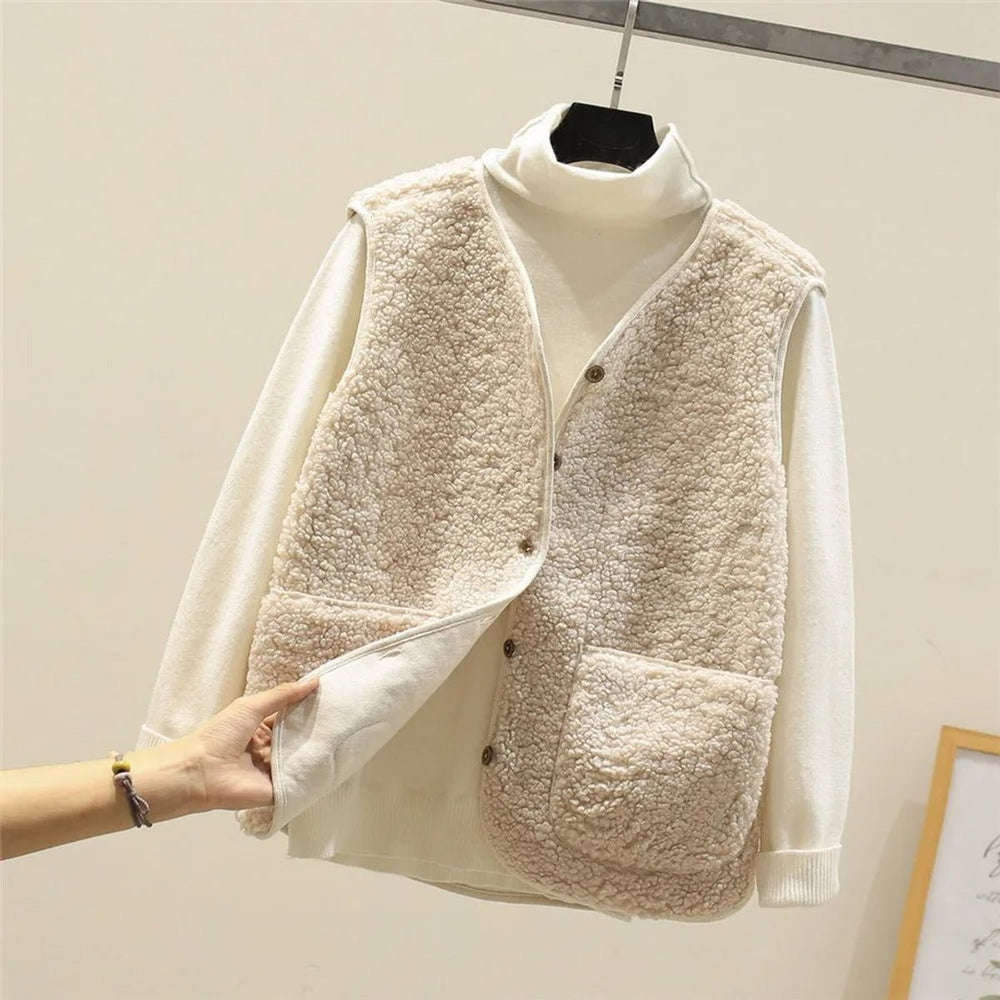 cream sherpa fleece puffer vest layered over ivory turtleneck sweater