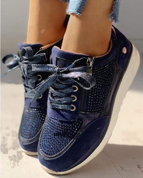 Navy suede lace-up sneakers featuring sparkly rhinestone accents and platform sole