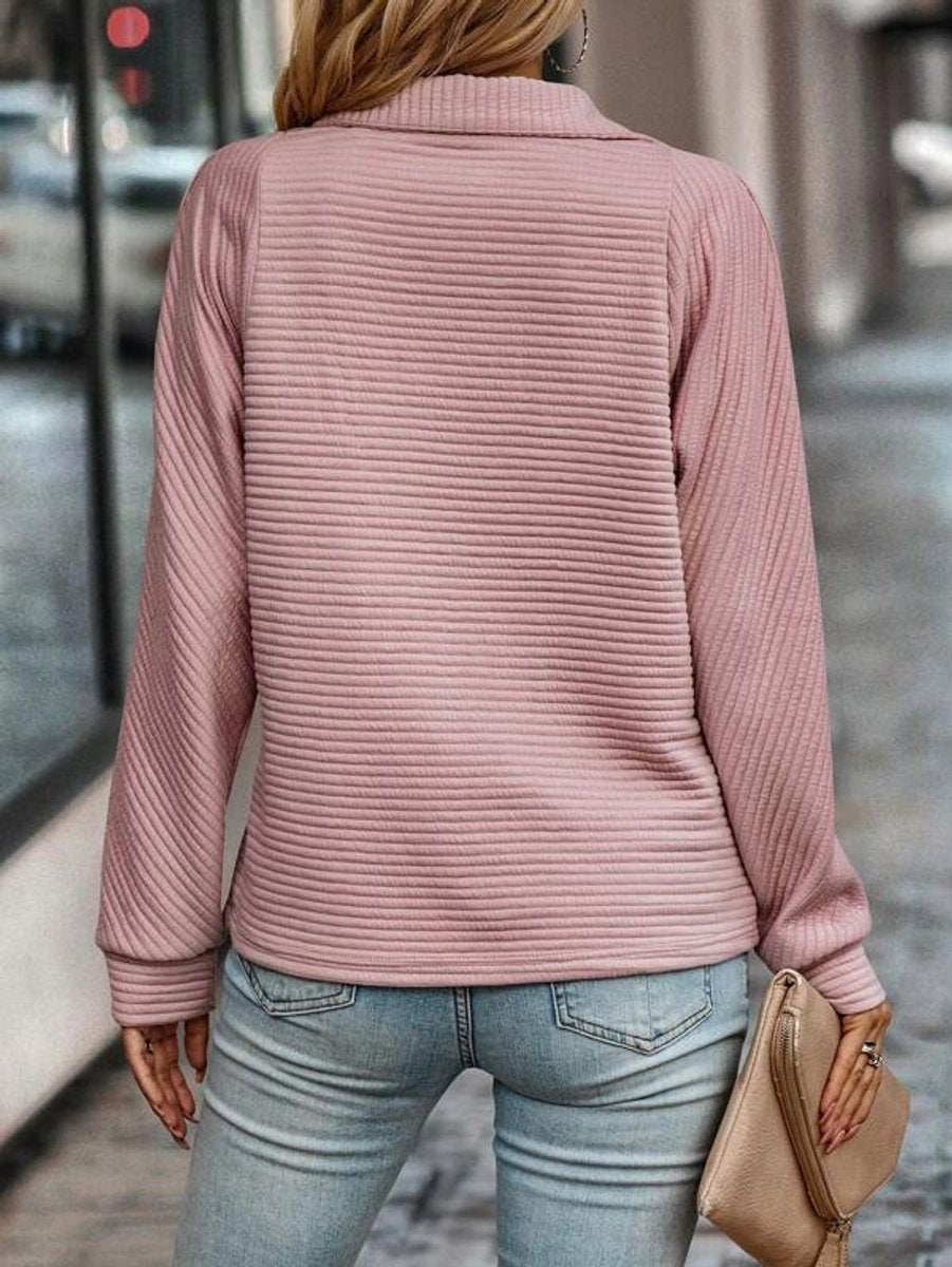 Back view of pink ribbed quarter-zip sweater showing textured knit