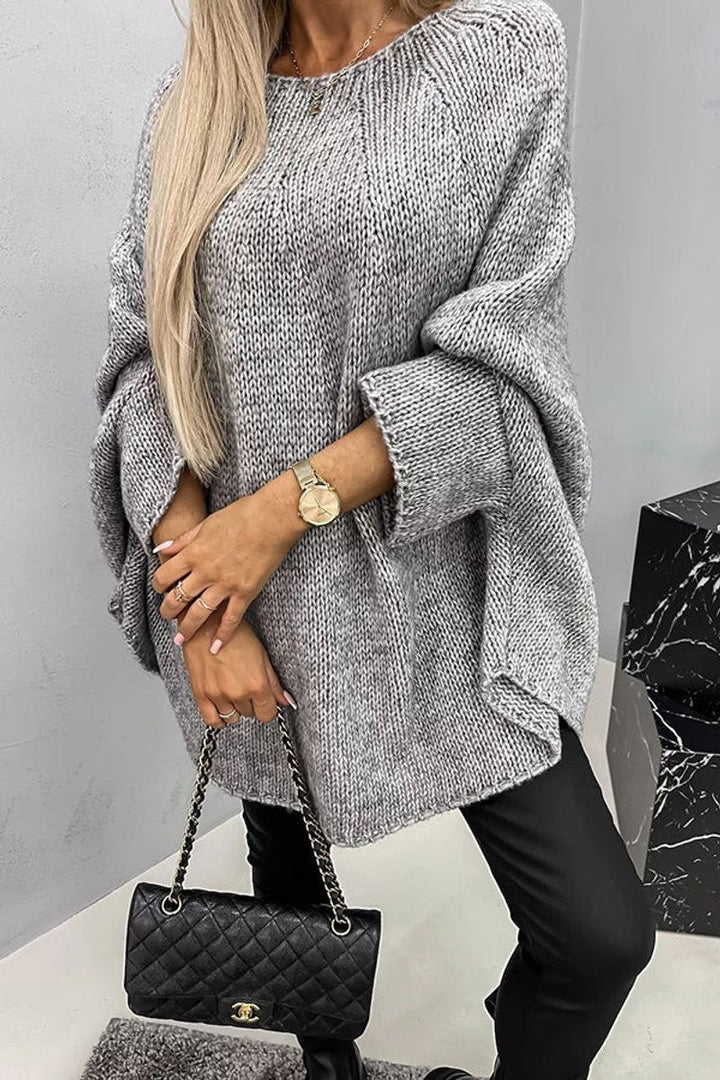 Gray chunky knit oversized sweater styled with black leather leggings