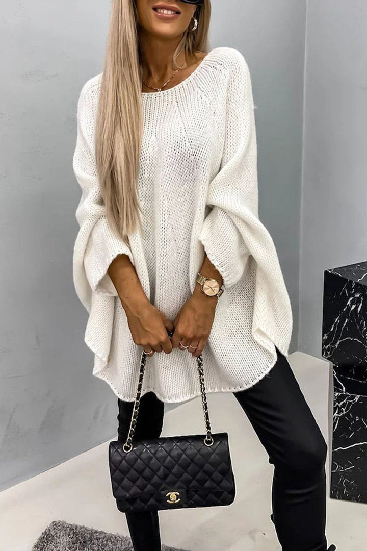White oversized knit sweater featuring wide batwing sleeves and round neck