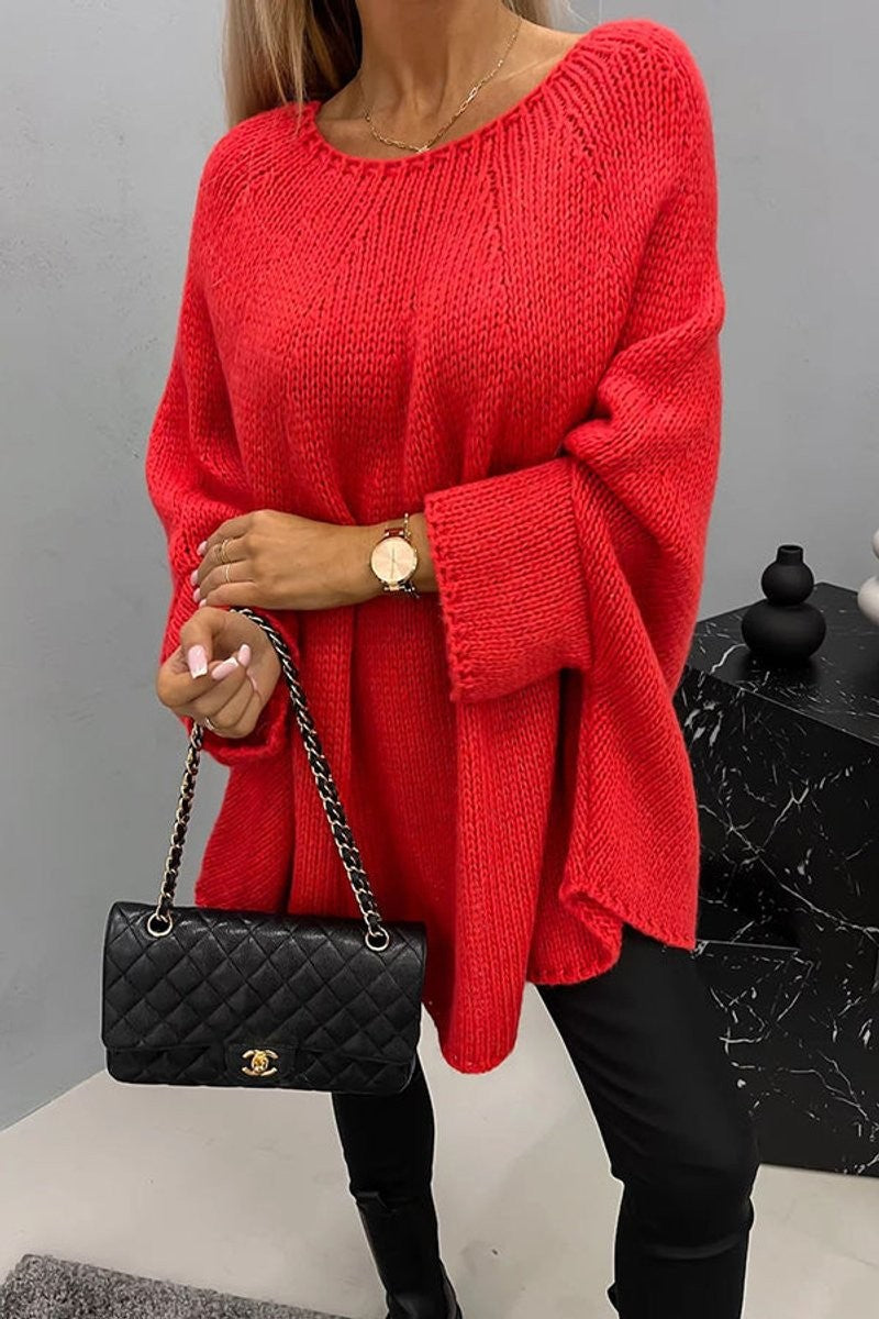 Red oversized knit sweater paired with a quilted black shoulder bag