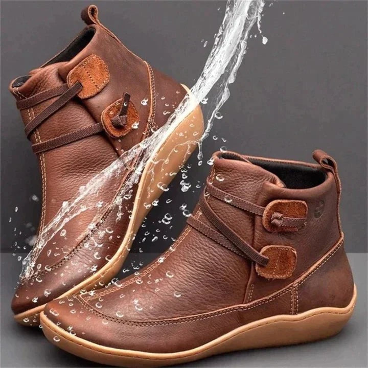 Brown leather ankle boots with buckle strap and water splash detail