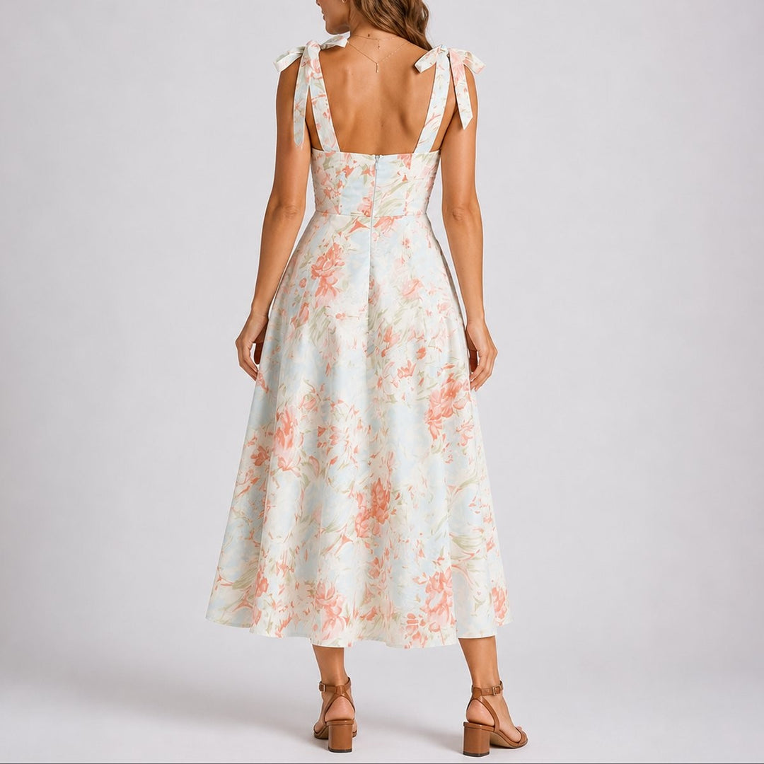 Coral floral midi dress back view with bow straps and flowing skirt